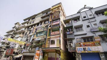 A multi-story building with various commercial establishments including a hotel, a printing shop, and a bank.