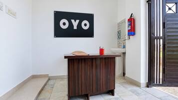 A reception desk with a sign that reads 'OYO' above it.
