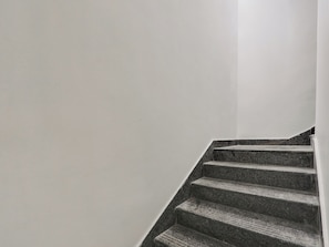 A staircase with a handrail and a white wall. - Hotel O Arjun Residency (Khammam)