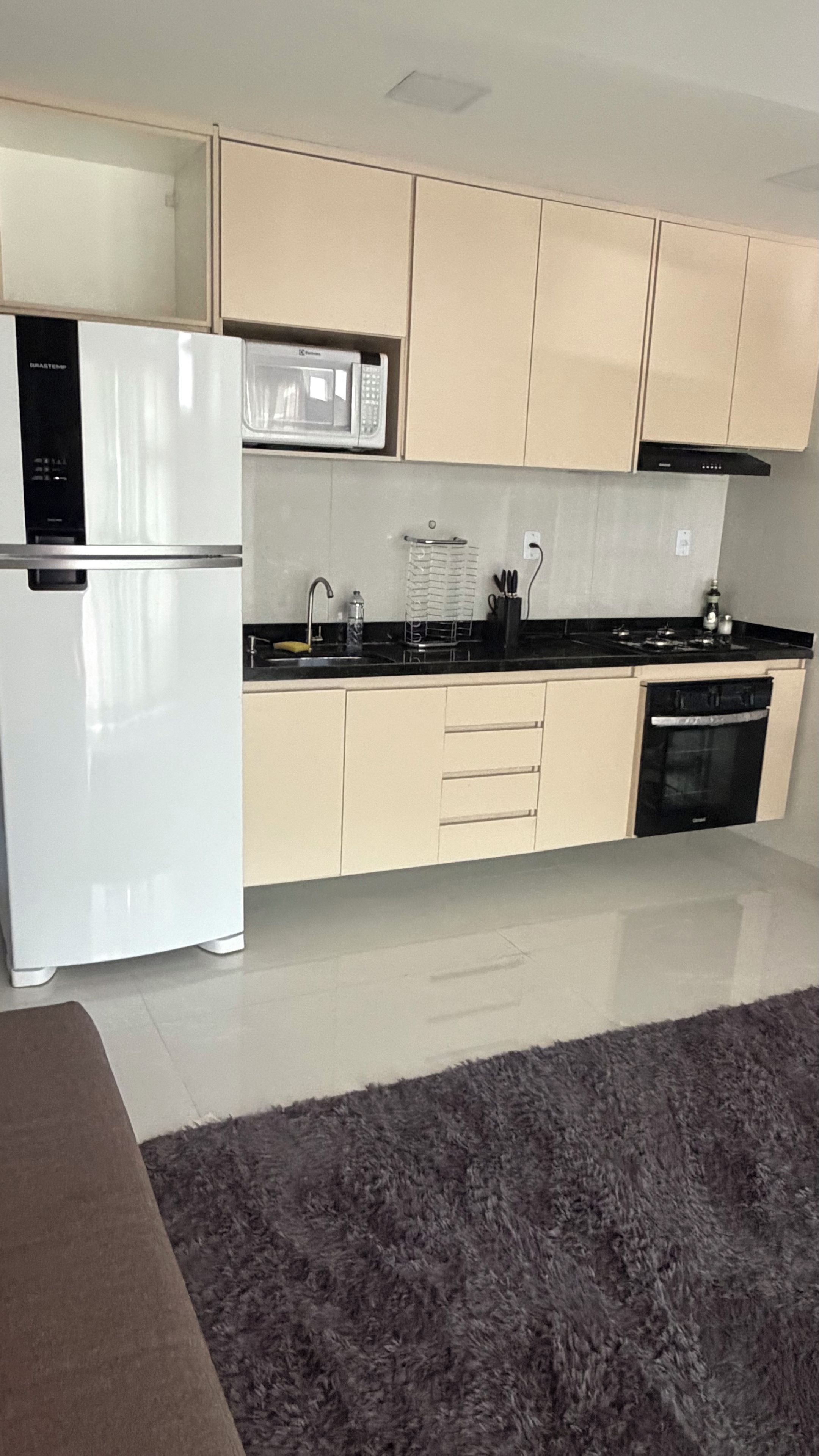 A modern kitchen with a refrigerator, microwave, stove, and dishwasher.