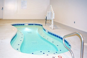 A small indoor swimming pool with a diving board and a no diving sign. - 3BR near West Entrance, Pool, Hot Tub, Game Room (West Yellowstone)