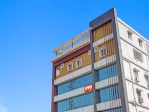 A multi-story building with a prominent 'OYO' sign on the facade. - HOTEL O SAI LEELA RESIDENCY (Karimnagar)