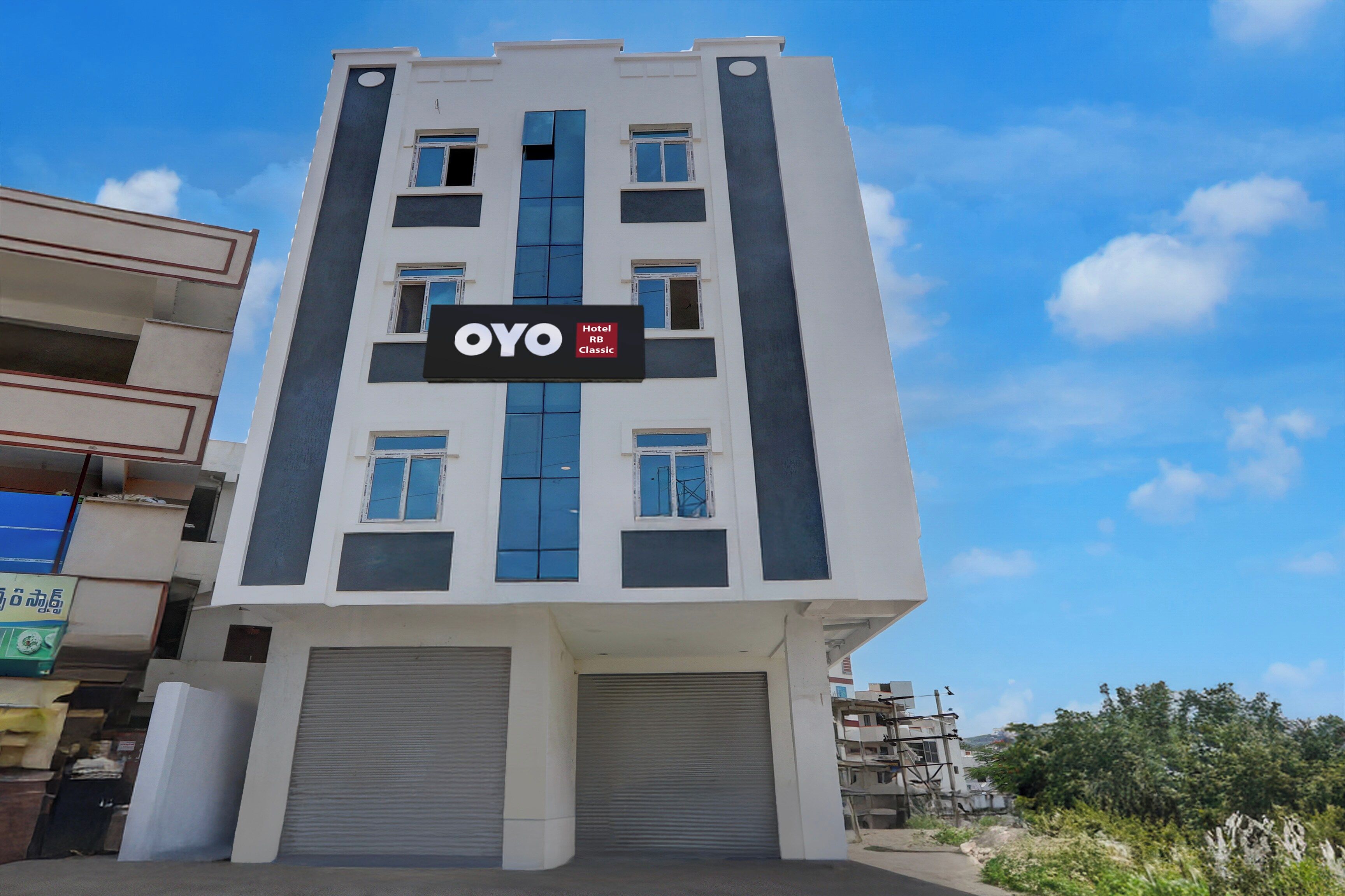 A modern hotel building with a sign indicating it is an OYO Hotel.