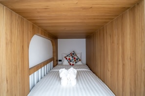 A small, narrow room with a single bed, a wooden ceiling, and a white wall. - Phuttho Pool Villa Khaokho (Khao Kho District)