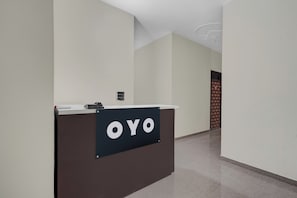 A reception desk with a sign that reads 'OYO' in a modern hotel lobby. - Hotel O Choudhary Hotal & Resort (Meerut)