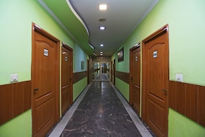 A hallway with doors numbered 207 to 210, leading to rooms.