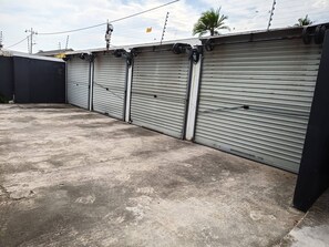A row of closed metal roller doors, likely for a commercial or industrial building. - Durban Cozy Stay - Free Wifi & Parking (Durban)