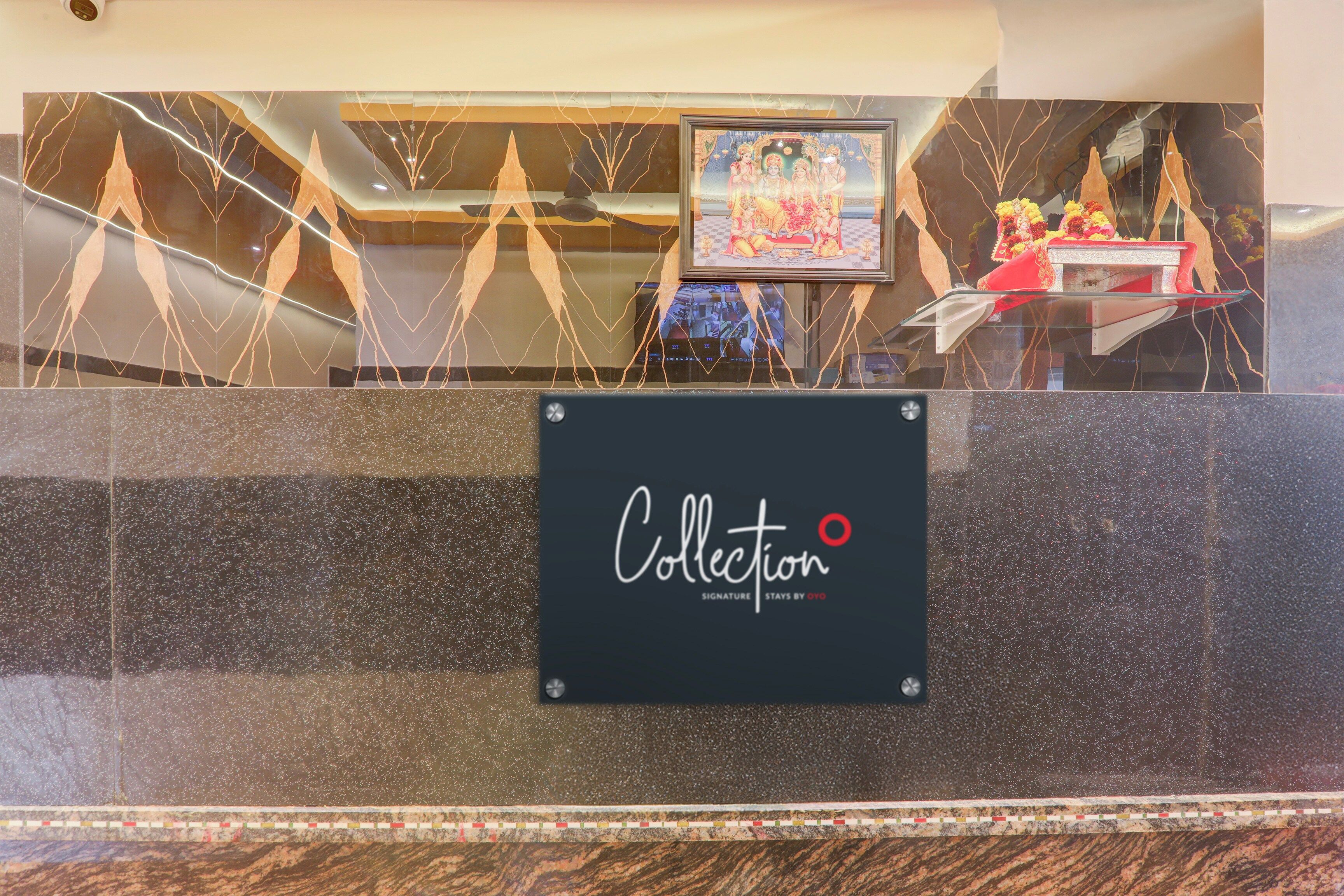 A reception desk with a sign that reads 'Collection Signature Stays by OYO.'