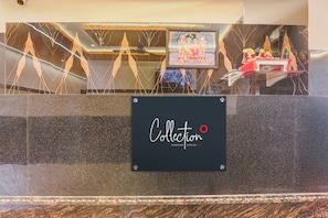 A reception desk with a sign that reads 'Collection Signature Stays by OYO.' - Collection O Siddharth Near A to Z (Kanpur)