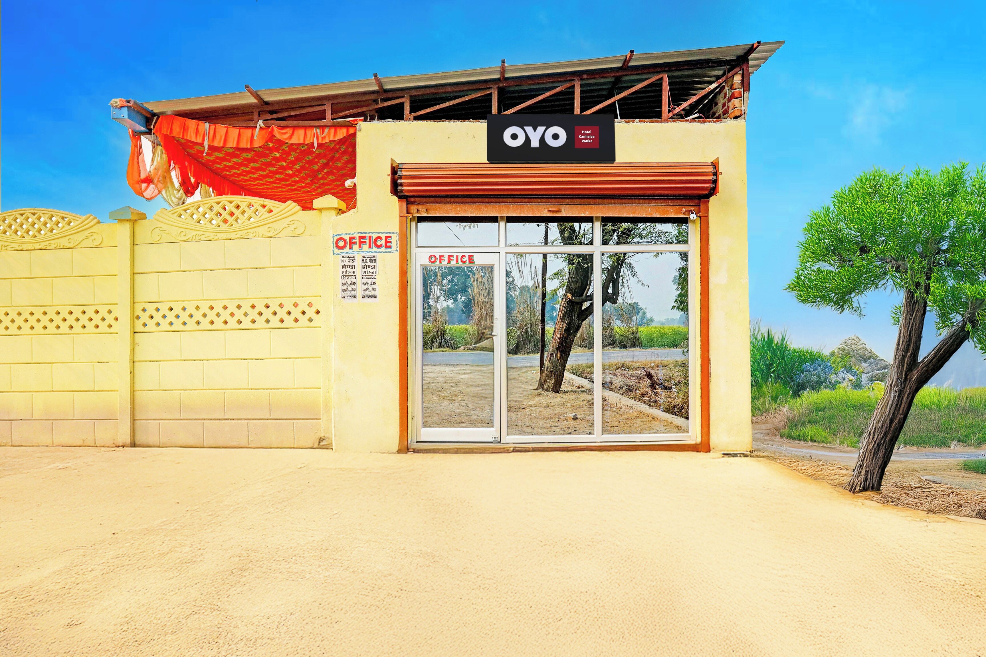 A hotel entrance with a sign reading 'OYO Hotel Kanhalya Vatika' and an 'OFFICE' sign on the wall.