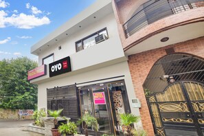A two-story building with a sign for 'Prayag Hotel' and 'OYO' indicating a hotel and OYO brand presence. - Hotel O by OYO Prayag Hotel (Ludhiana)
