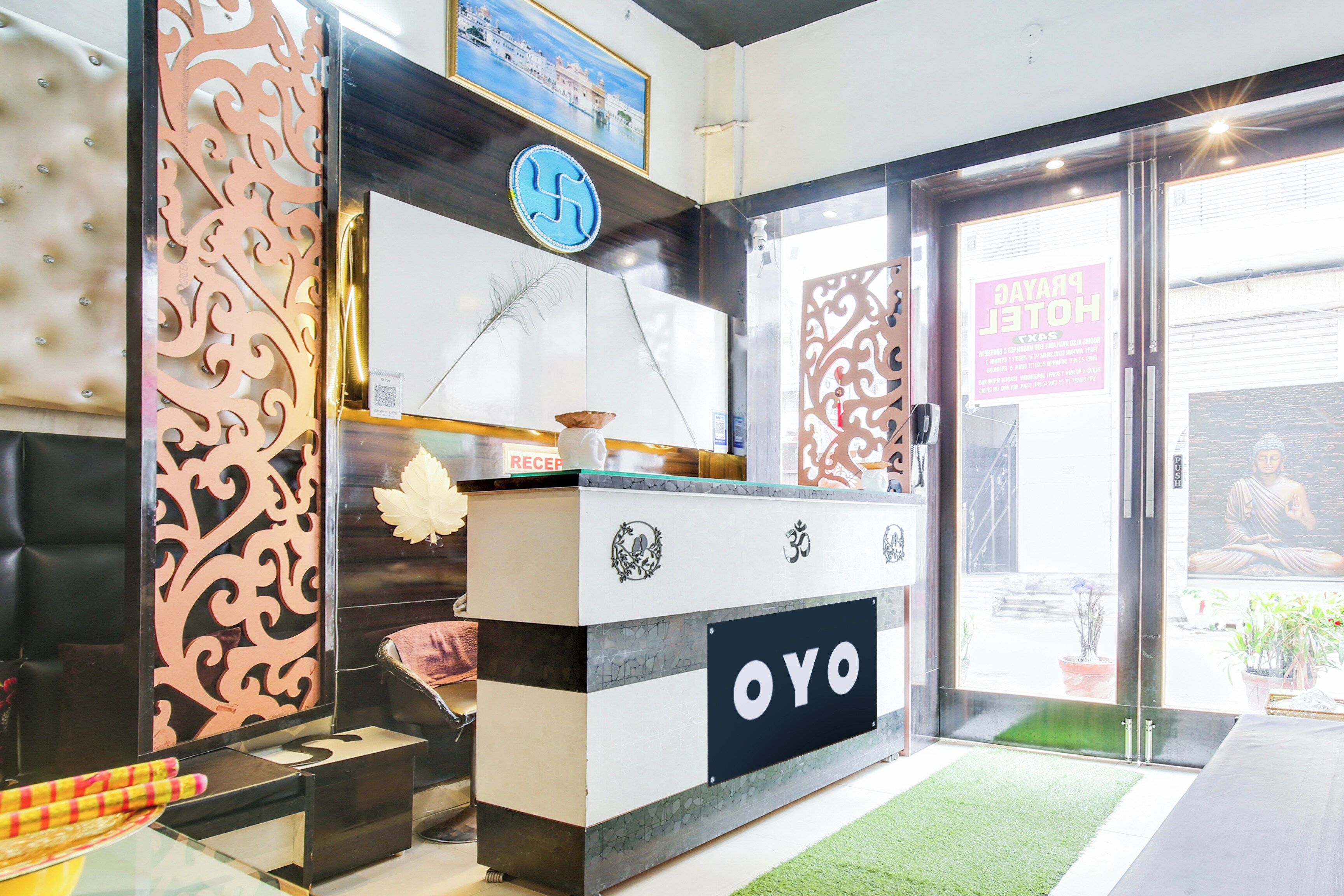 A reception desk with a logo, a sign with a symbol, and a door with a sign.