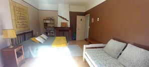 A bedroom with a bed, bedside table, lamp, and a bookshelf. - New Listing (Saint-Jean-du-Gard)