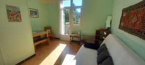 A room with a bed, a desk, a chair, a window, and a wall with a tapestry. - New Listing (Saint-Jean-du-Gard)