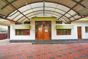 A building with a covered entrance, a wooden door, and a sign indicating visitors are not allowed. - Collection O Lala Homes (Kochi)