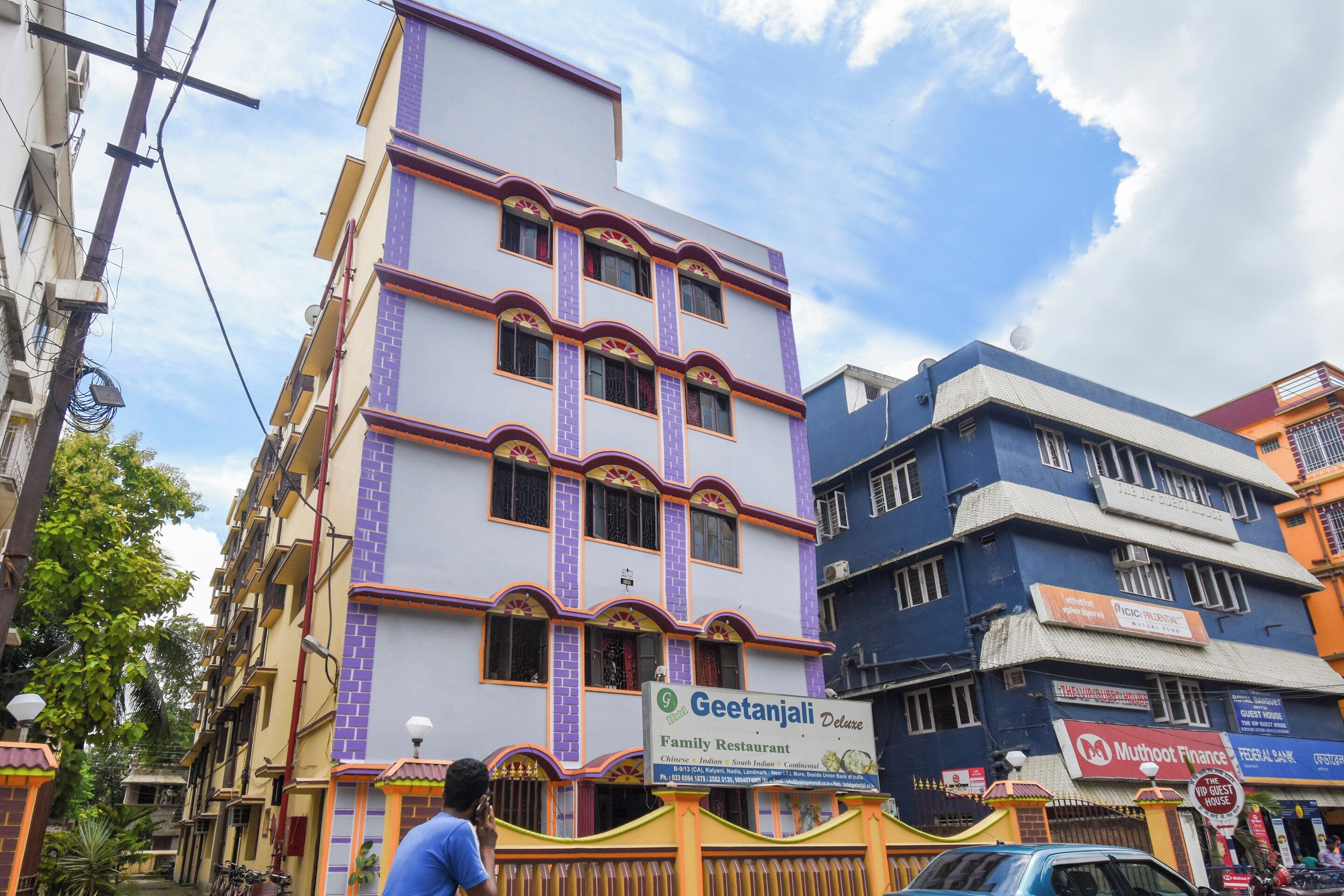 A multi-story building with a sign for Geetanjali Family Restaurant.