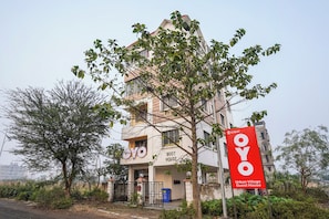 A multi-story building with a sign indicating it is an 'Urban Village Guest House.'