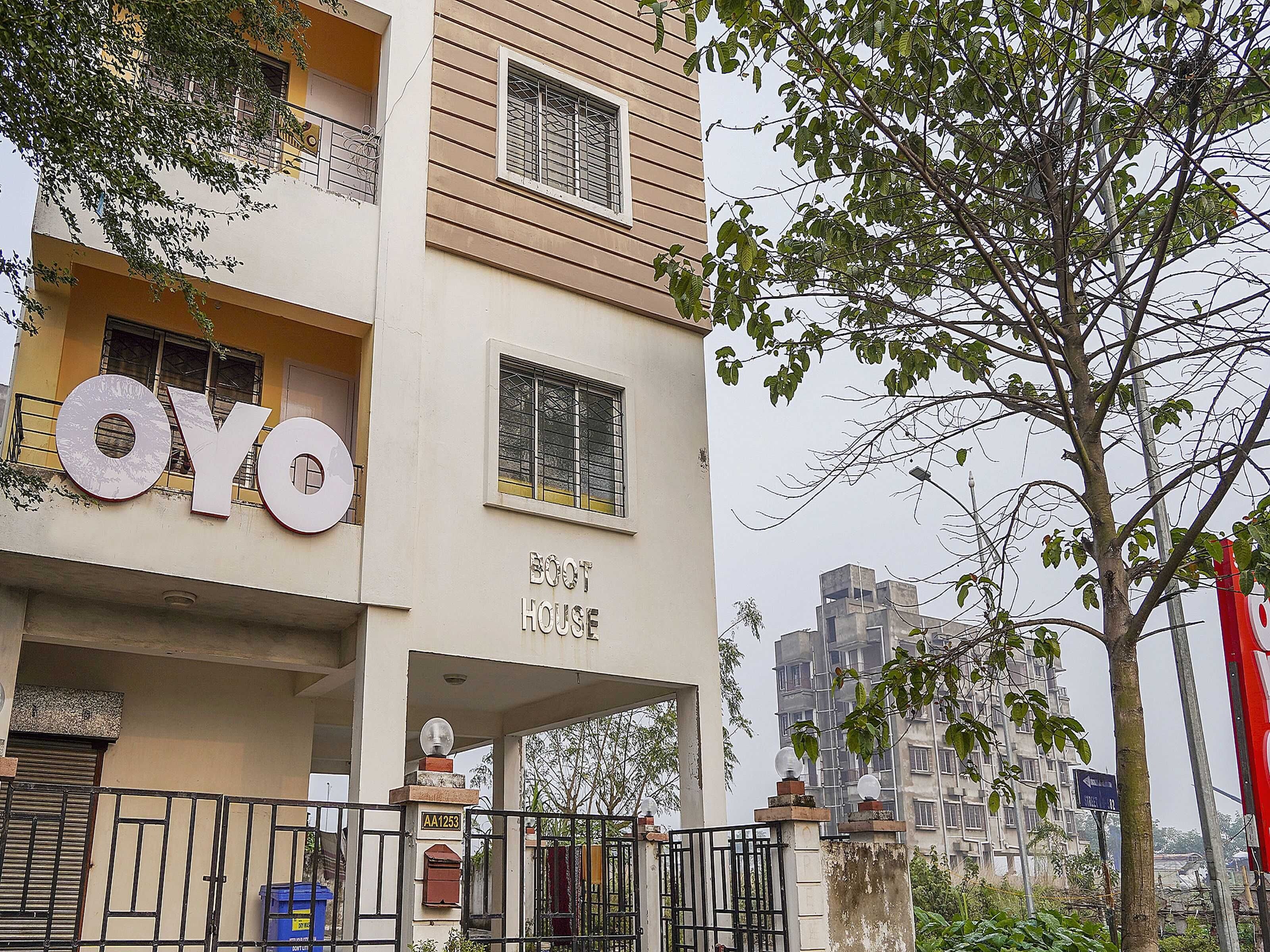 A multi-story building with a prominent 'OYO' sign on the facade, indicating a hotel or hostel.