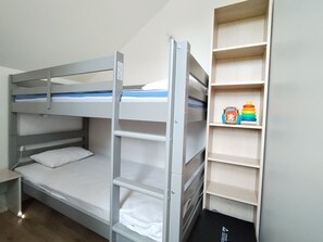 A bunk bed with a ladder, a small desk, and a shelf with toys. - New Listing (Meschers-sur-Gironde)