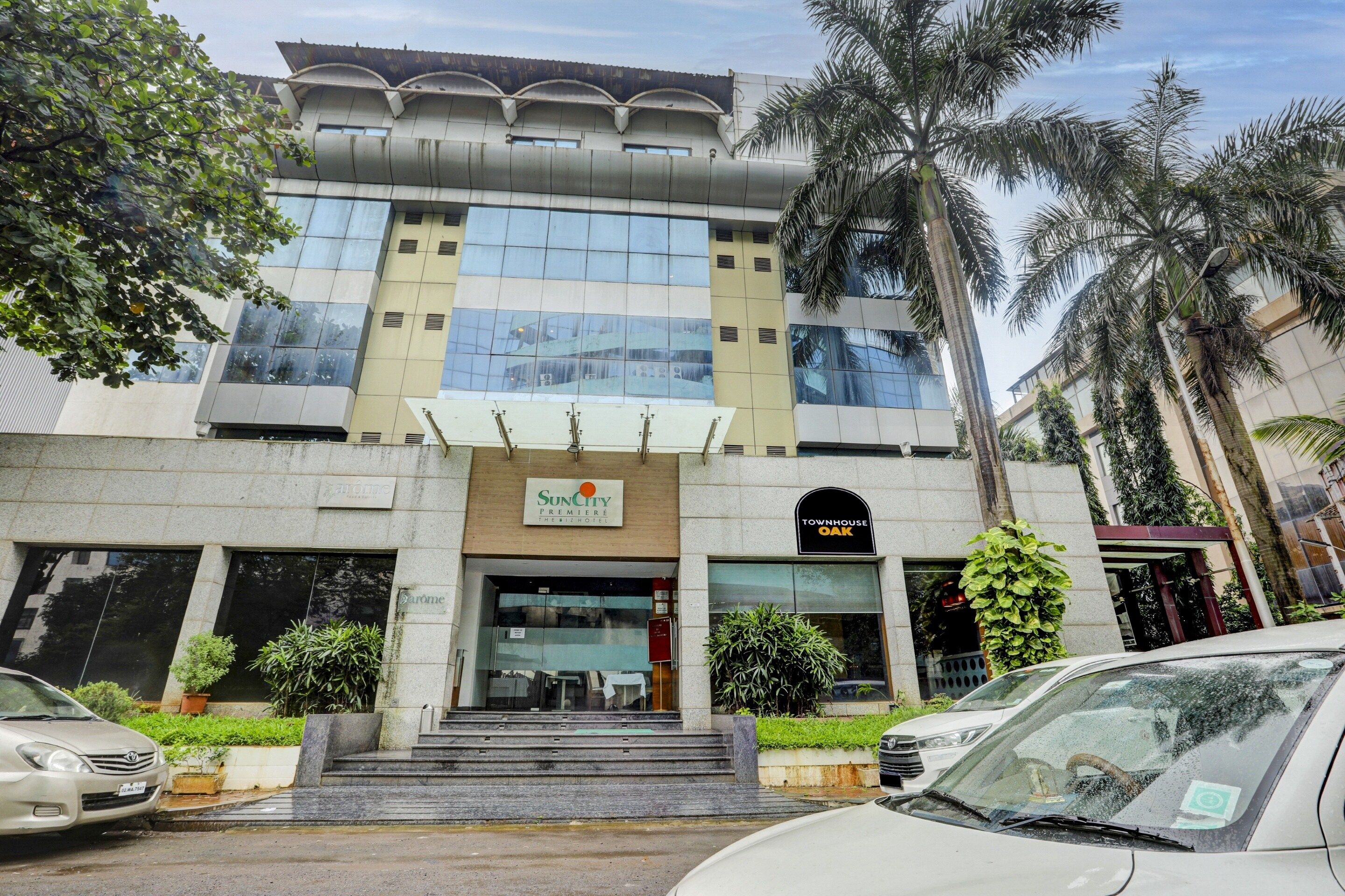 A multi-story hotel with a modern facade, featuring a prominent entrance with steps leading up to the main doors.