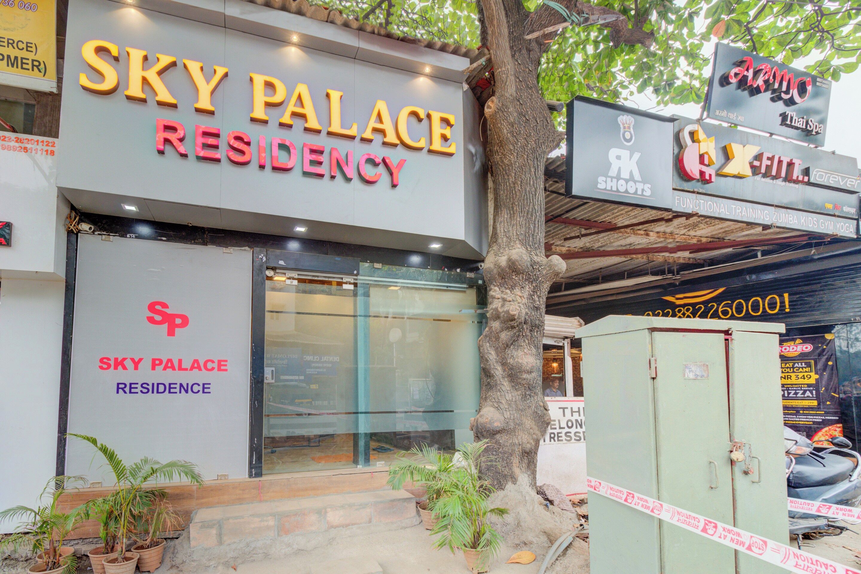 A building with a sign that reads 'SKY PALACE RESIDENCY'.