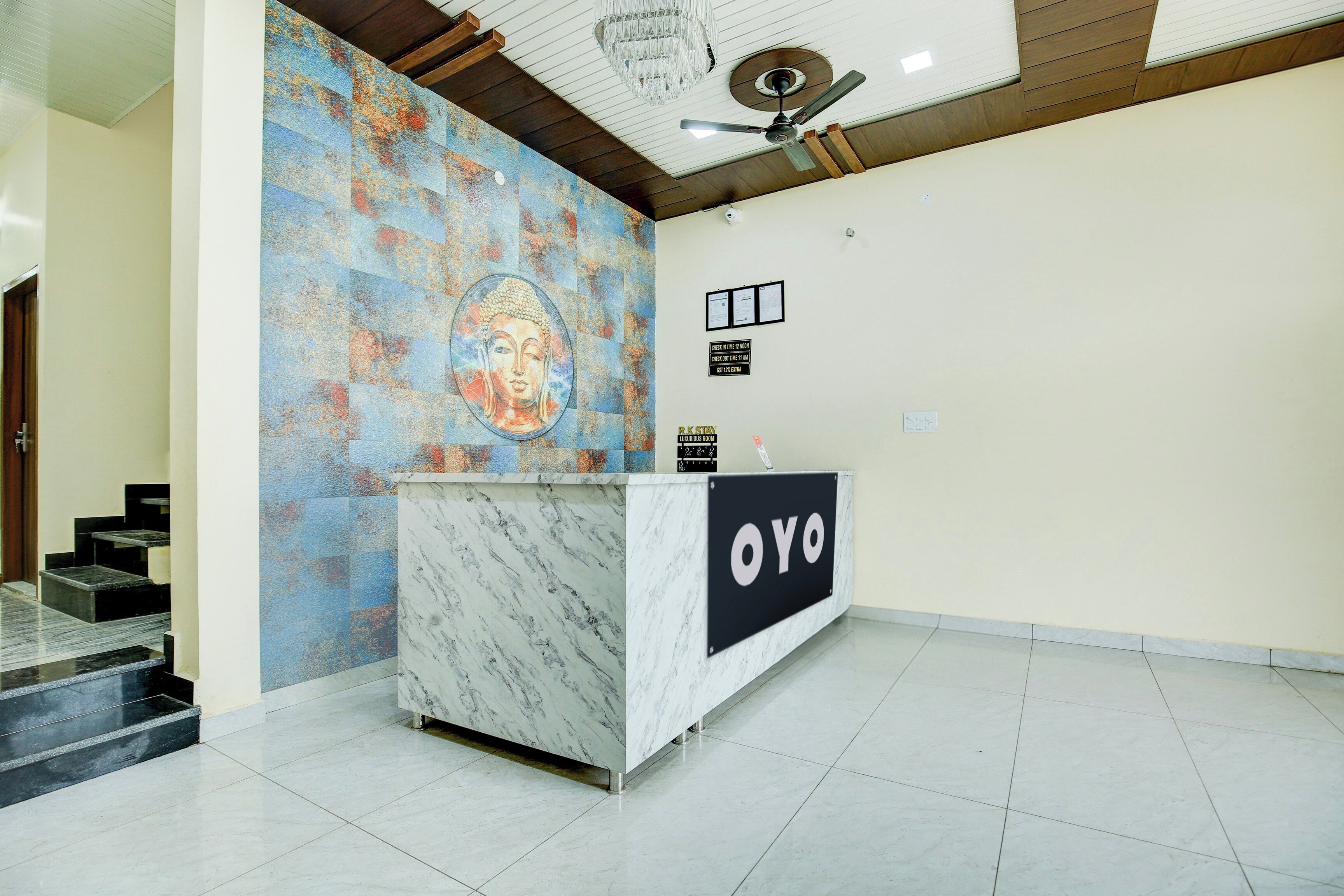 A reception desk with a marble top and a sign that reads 'OYO'.