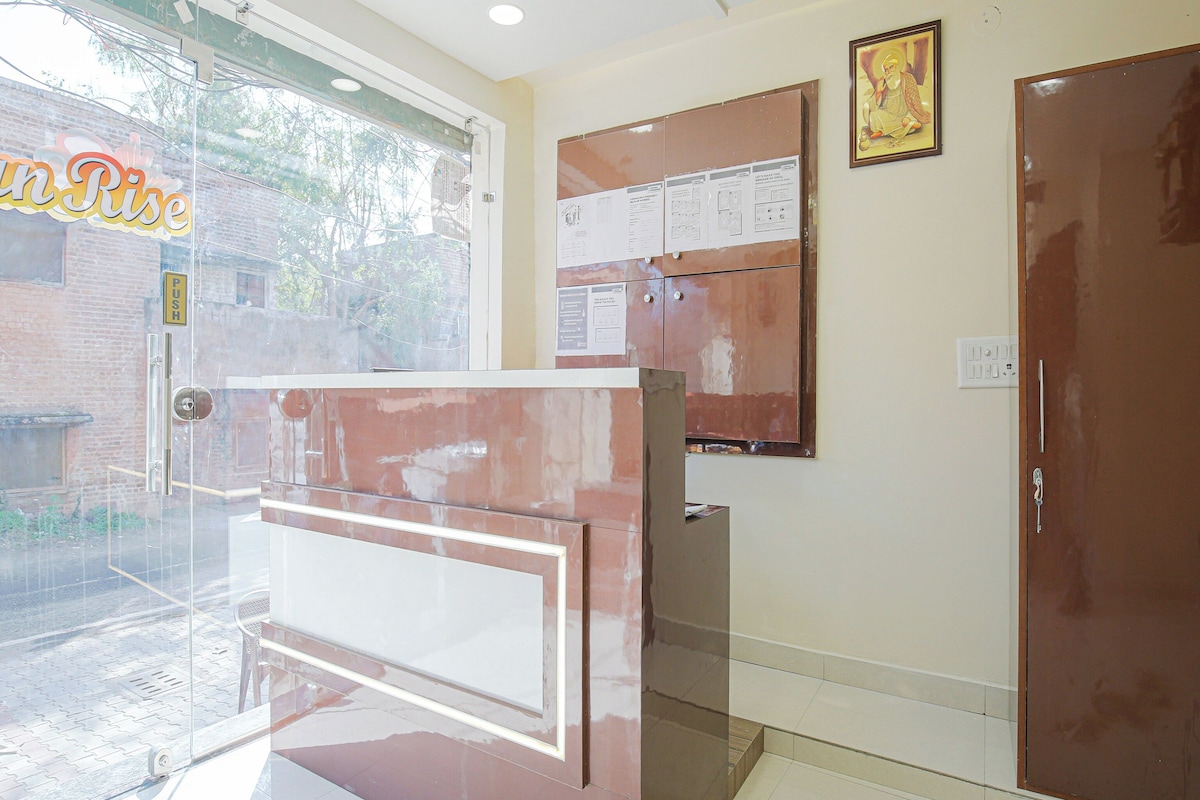 A reception area with a glass door, a bulletin board, and a closed door.