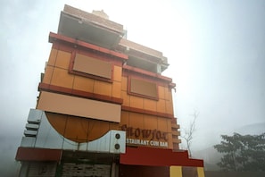 A multi-story building with a sign for 'Restaurant Cum Bar' at the ground level. - Collection O Snowfox (Kolkata)