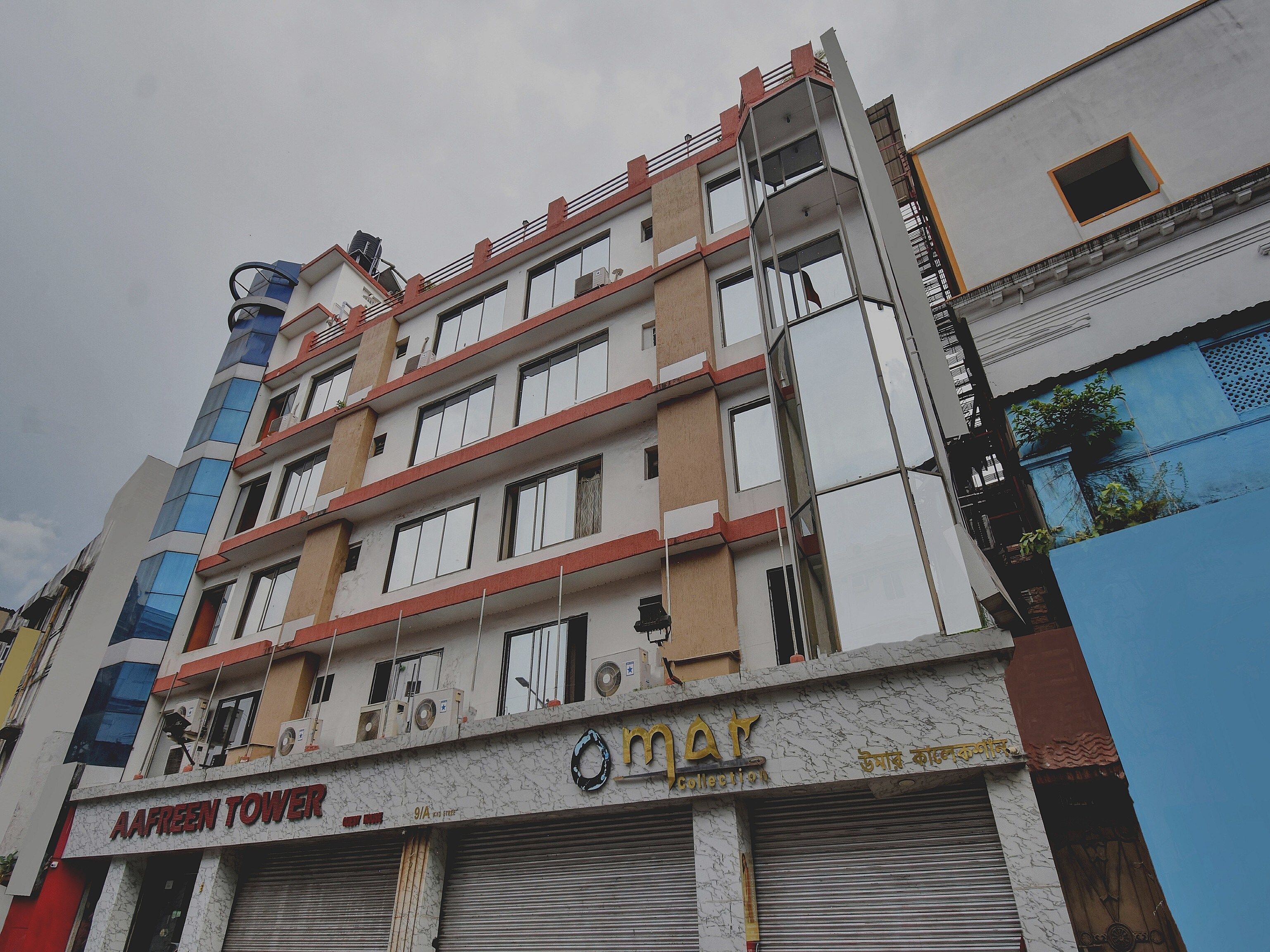 Un edificio de varios pisos con una fachada comercial en la planta baja.