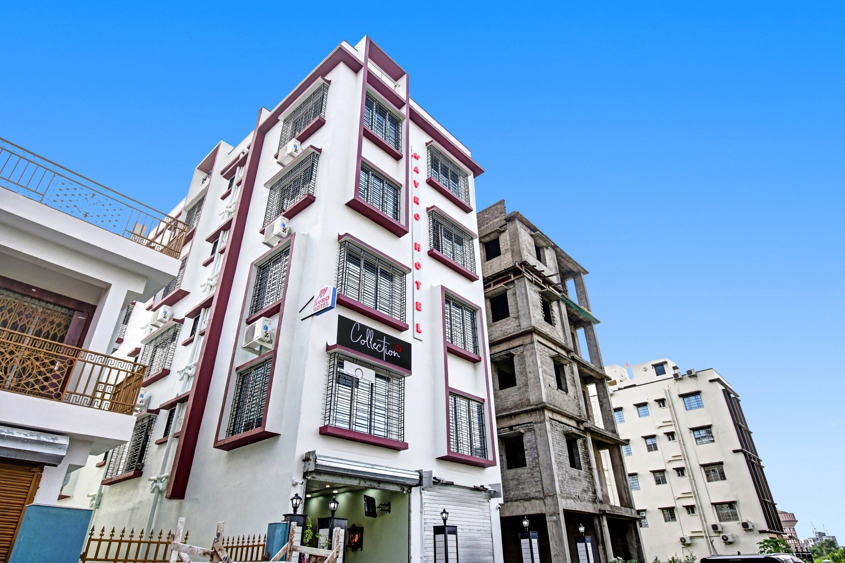 A multi-story hotel with a modern facade, multiple balconies, and a sign indicating it is a collection hotel.