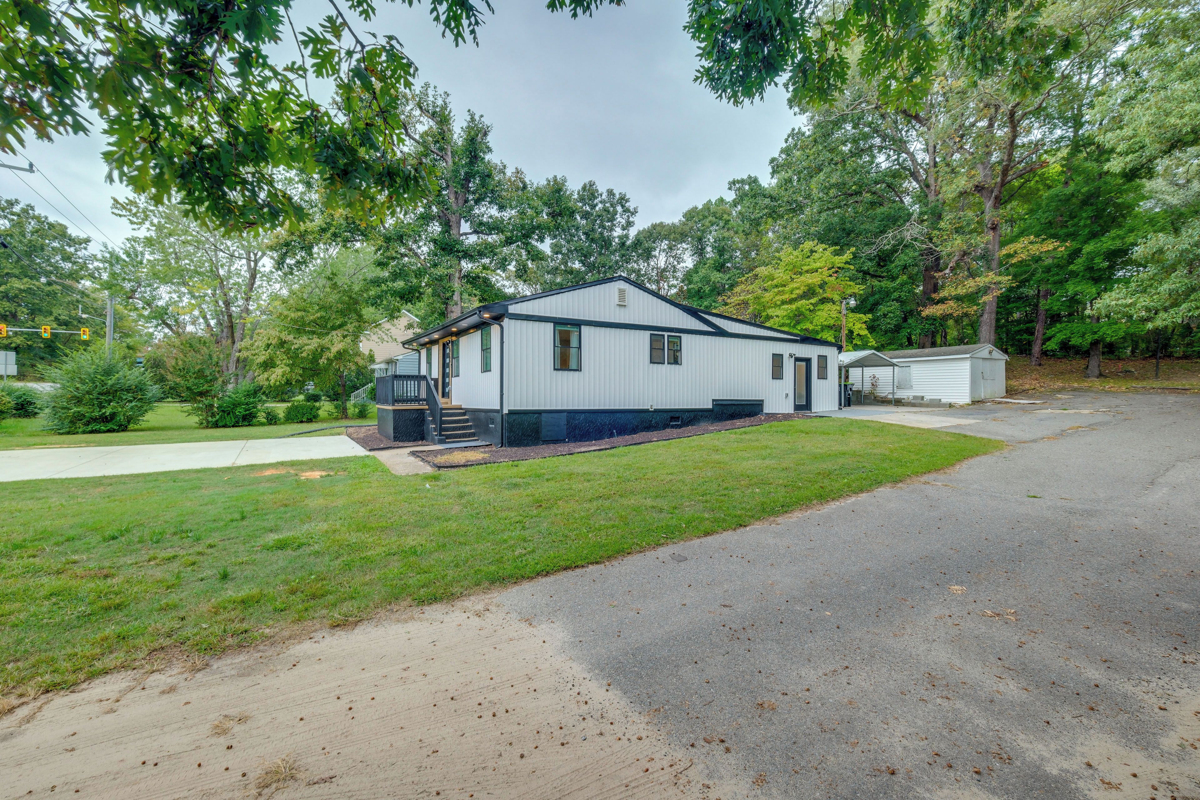 A single-story mobile home with a front porch and a small attached garage.