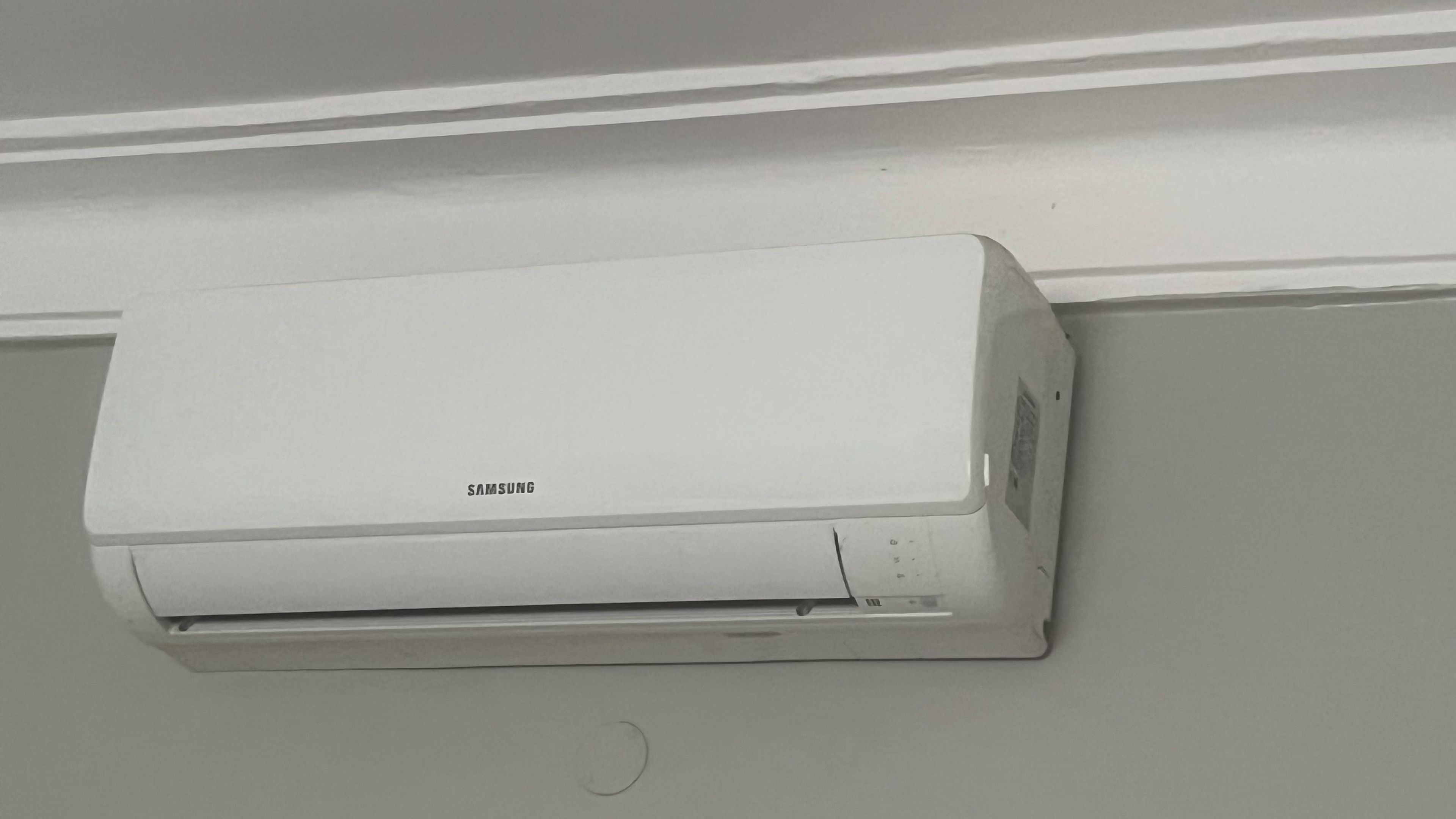 A white Samsung air conditioner mounted on a wall.