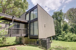 A modern two-story building with a flat roof, large windows, and a metal facade. - Mid-century Modern Chateau du Coach House (Iowa City)