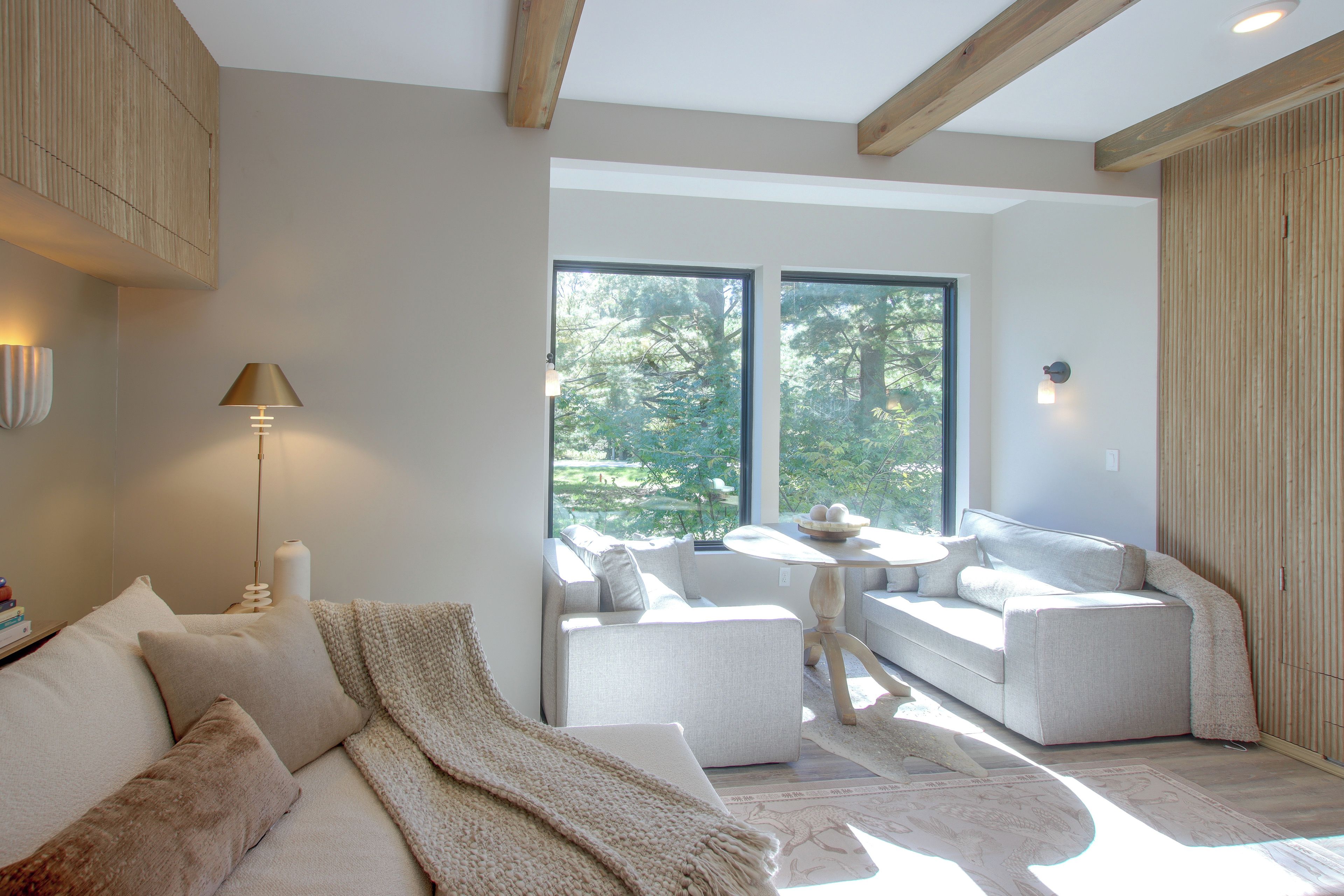 A modern living room with a sofa, a coffee table, and a lamp.