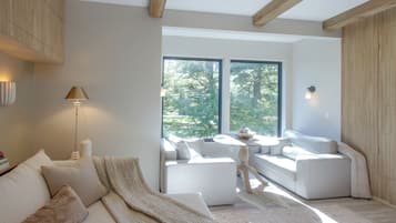 A modern living room with a sofa, a coffee table, and a lamp.