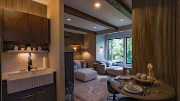 A modern interior with a kitchen, dining area, and seating space with large windows.