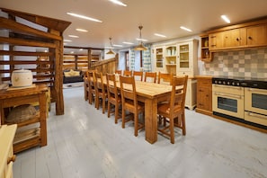 A spacious kitchen with wooden furniture, a dining table, and modern appliances. - Host Stay - Ethel s Escape (York)