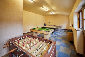 A room with a foosball table, pool table, and ping pong table. - Host Stay - Clover Leaf Cottage (York)