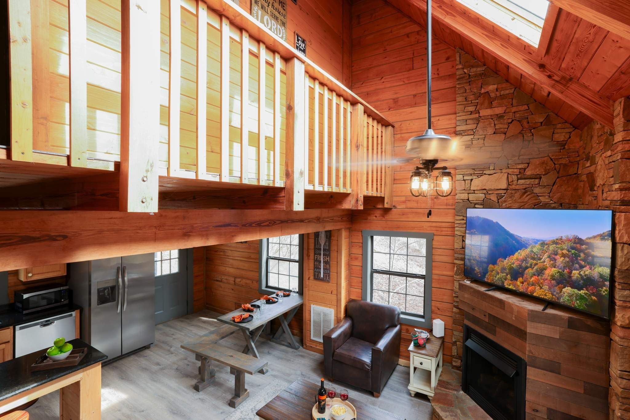 A spacious loft-style living area with a kitchen, dining table, and a fireplace.
