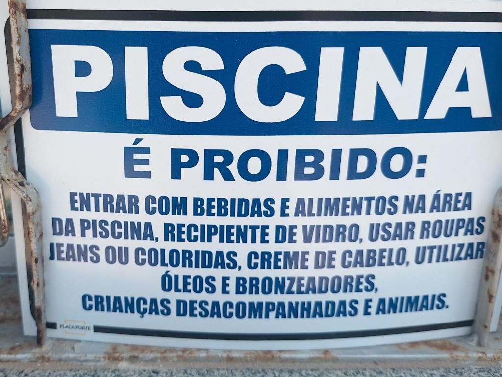 Ein Schild mit einer Auflistung verbotener Gegenstände in einem Schwimmbereich.