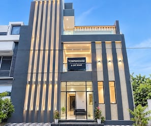 A modern townhouse with a prominent sign reading 'TOWNHOUSE & OFF ROAD.' - Classic Hotel Expression (Indore)