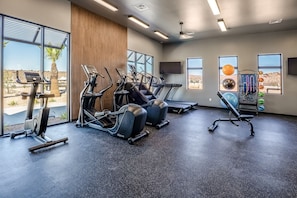 A gym with treadmills, a rowing machine, and a weight bench. - The Desert Isle 5 Bedroom Townhouse (Washington)