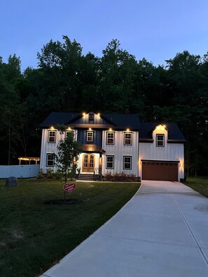 A two-story house with a front porch, a garage, and a well-maintained lawn. - The Best Place for Family Stays, and Small Group (Mint Hill)