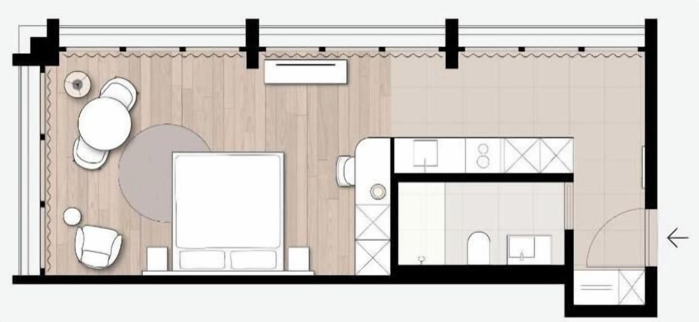 Un aménagement de chambre d’hôtel comprenant un lit, un coin salon et une kitchenette.
