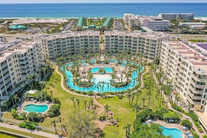 A resort with multiple buildings, a central pool area, and a view of the ocean. - Bayfront Paradise! Lazy River, Beach Access & Private Patio! (Fort Walton Beach)