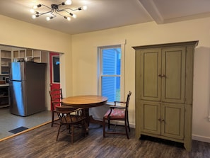 A kitchen with a refrigerator, wooden chairs, a table, and a cabinet. - Functional 3-bedroom apartment in delightful Montpelier perfect for families (Montpelier)