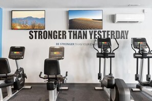 A gym with treadmills, stationary bikes, and a motivational quote on the wall. - Prime Studio City Hideaway | Gym Pass | Fits 2 (Philadelphia)