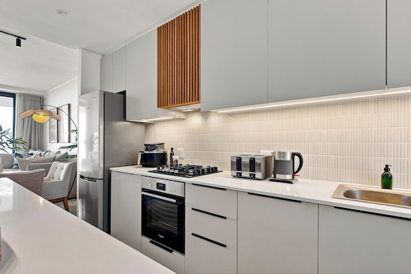 Eine moderne Küche mit Einbauofen, Kaffeemaschine und Toaster.