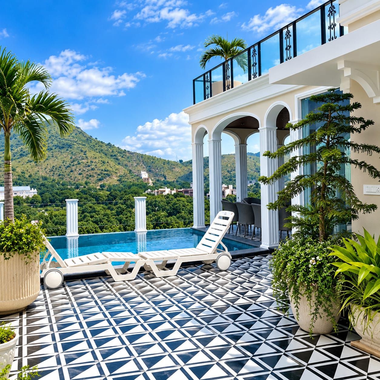 A rooftop pool area with lounge chairs, a patterned floor, and a view of a mountain.