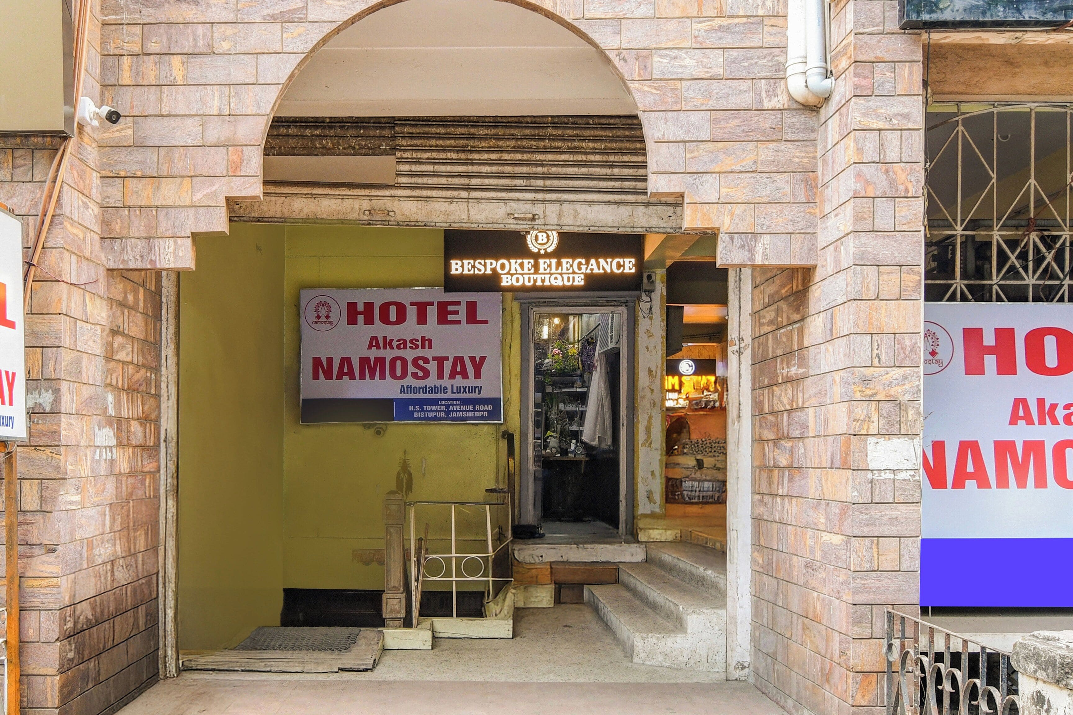 A hotel entrance with a sign for 'Hotel Namostay' and 'Bespoke Elegance Boutique' above it.